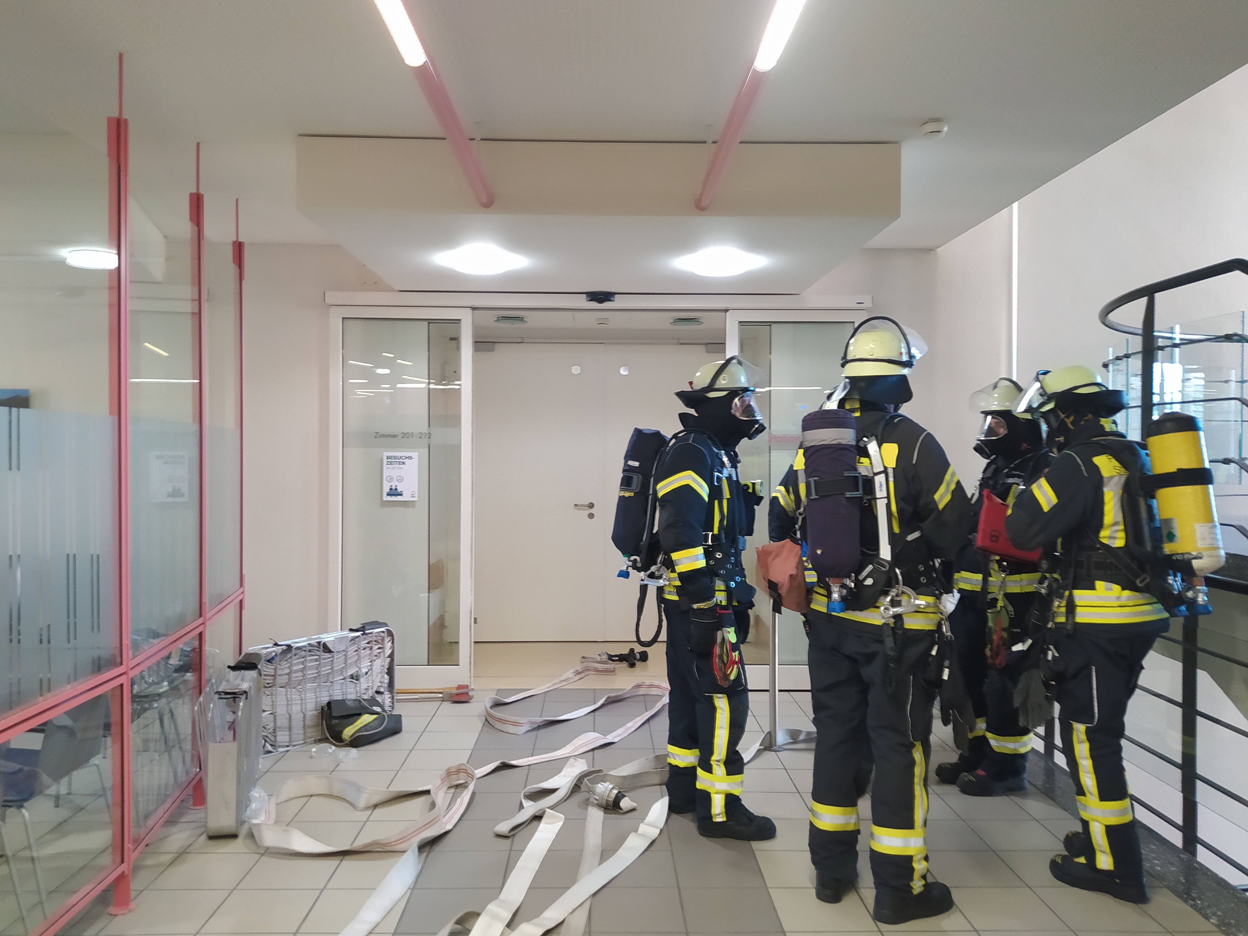 Einsatzkräfte nach der erfolgreichen Brandbekämpfung auf Station 2A.